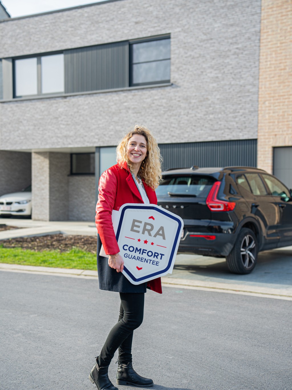 An ERA broker holds an ERA Comfort Guarantee V-Board.